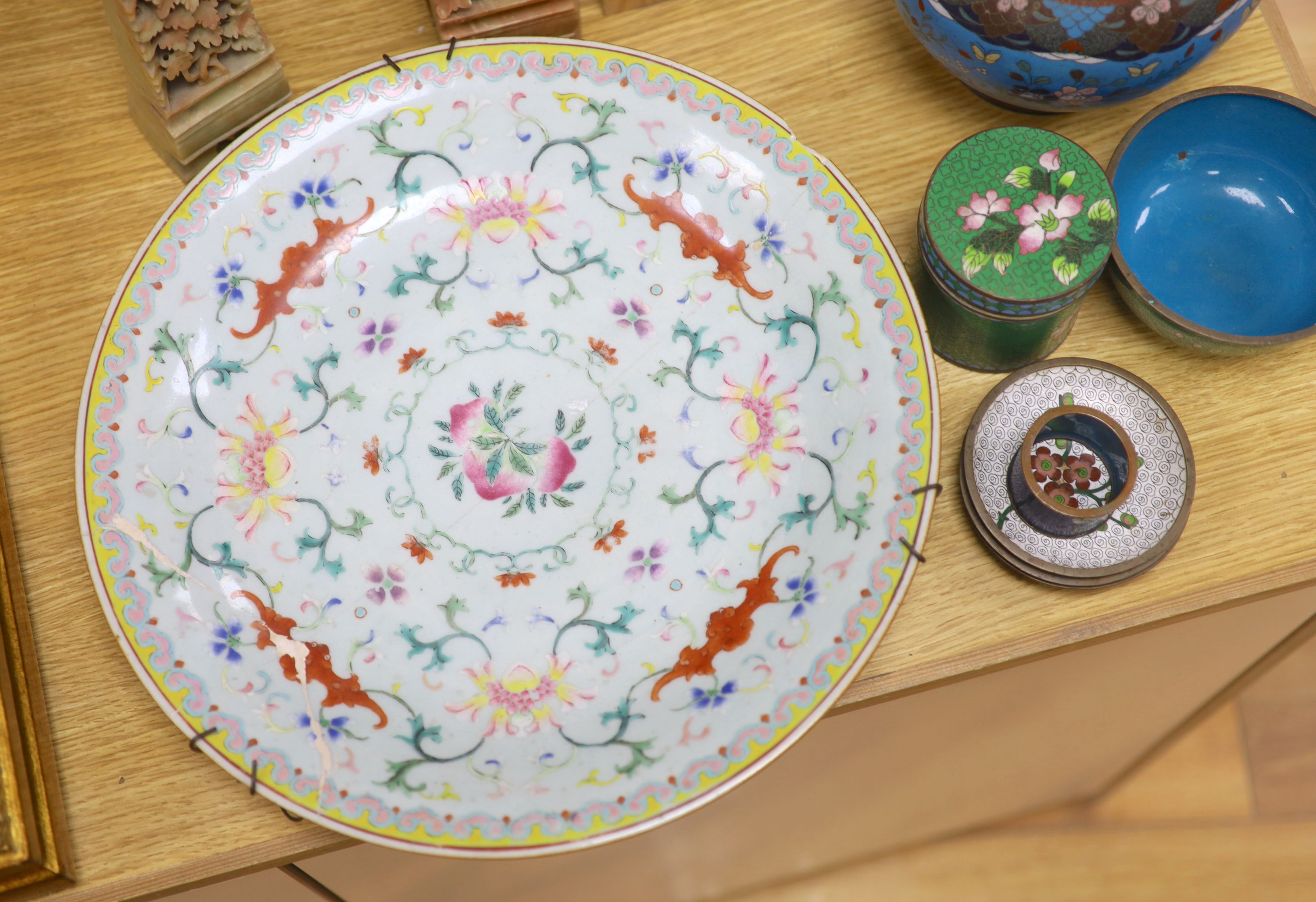 A group of Chinese and Japanese wares to include a famille rose dish, mixed cloisonne and a pair of soapstone carving, largest diameter